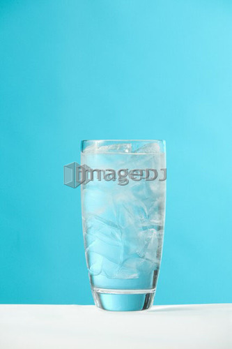 Very full glass of water with ice