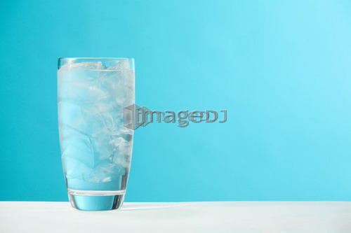 Very full glass of water with ice