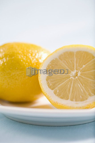 lemon and half lemon on plate