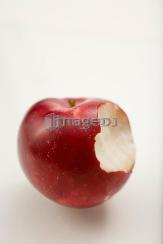 Organic apple with bite taken out