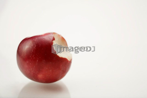 Organic apple with bite taken out