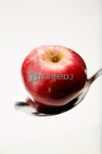 Organic apple in spoon