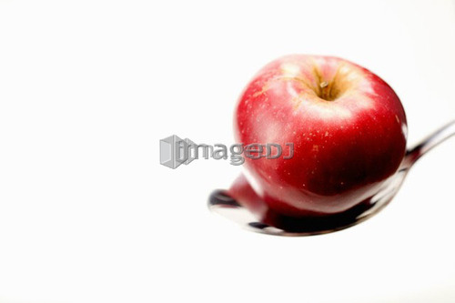 Organic apple in spoon