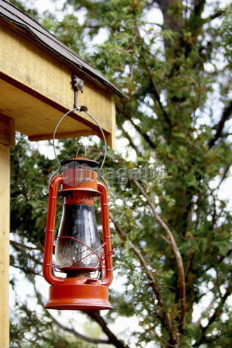Red lantern hanging from corner of shed