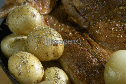 Roasted potatoes with roast pork sprinkled with spices