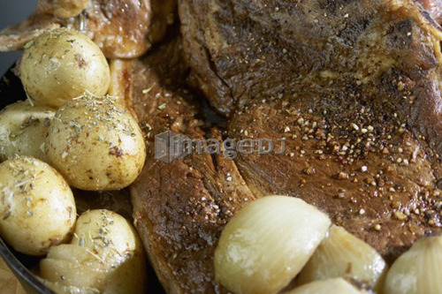 Roasted potatoes with roast pork sprinkled with spices