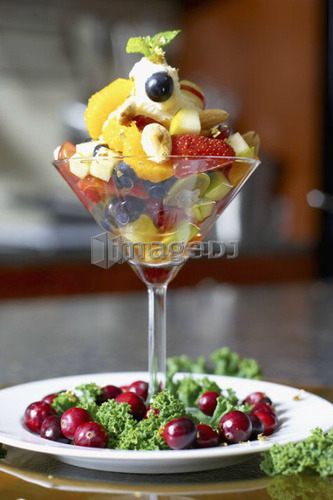 Festive fruit cocktail with mascarpone cheese in a martini glass garnished with cranberries