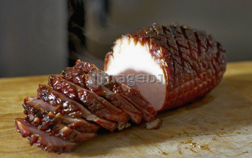 Oven roasted ham sliced up on cutting board
