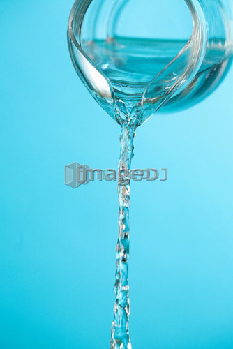 Stream of water being poured from a pitcher