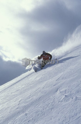 Young man skiing untracked slope at Castle Mountain Resort, Alberta, Canada