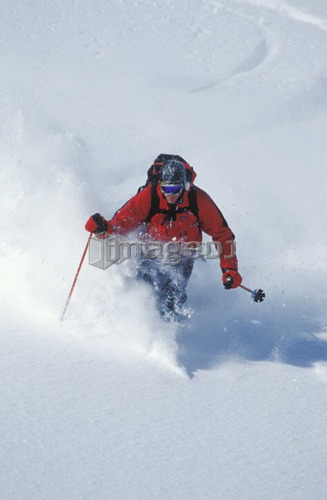Young man skiing untracked powder in the backcountry near Fernie, British Columbia, Canada