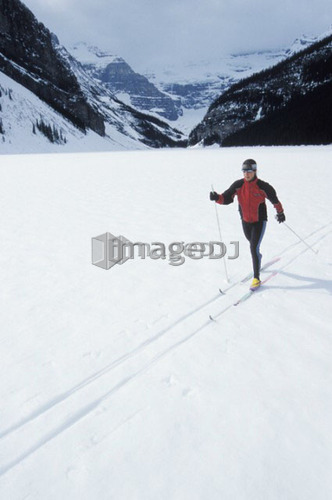 Young woman cross country skiing on Lake Louise, Banff National Park, Alberta, Canada
