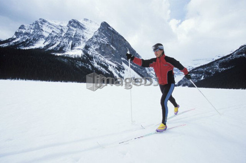 Young woman cross country skiing on Lake Louise, Banff National Park, Alberta, Canada