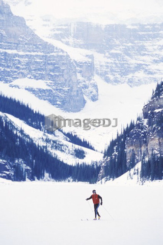 Young woman cross country skiing on Lake Louise, Banff National Park, Alberta, Canada
