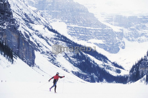 Young woman cross country skiing on Lake Louise, Banff National Park, Alberta, Canada