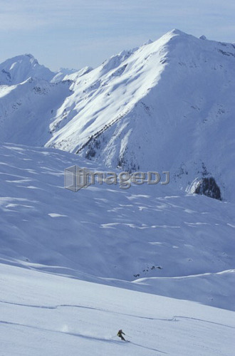 Young woman skiing fresh powder at Mica Heliskiing, Mica Creek, British Columbia, Canada