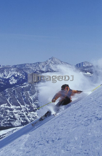 Young man skiing at high speed on ungroomed slope near Fortress Mountain, Alberta, Canada.