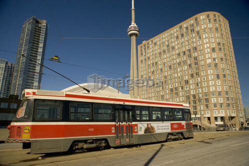 Streetcar in Toronto in front of CN Tower and Rogers Centre, formerly the Skydome