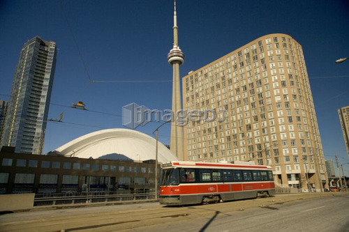 Streetcar in Toronto in front of CN Tower and Rogers Centre, formerly the Skydome