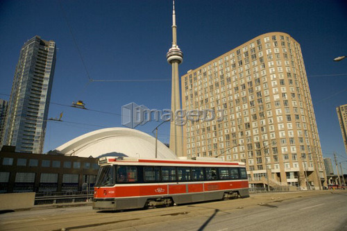 Streetcar in Toronto in front of CN Tower and Rogers Centre, formerly the Skydome