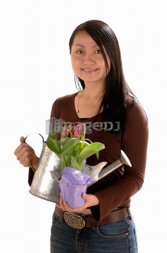Asian Young girl w/watering can, Regina, Saskatchewan