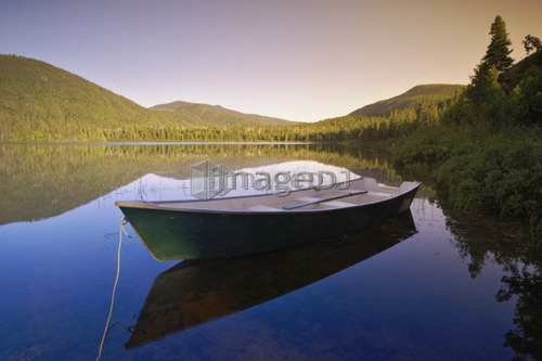 View of boat at Lebreux lake at sunset, Quebec
