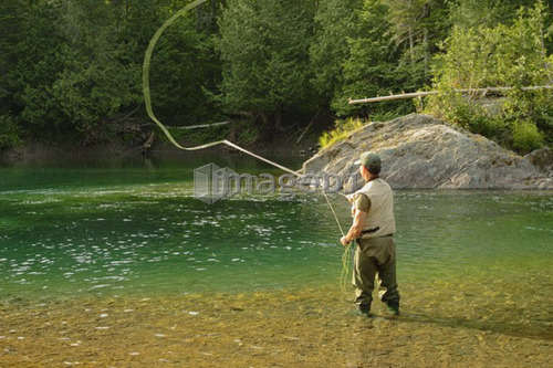 View of fisherman (salmon fishing) on Petite Cascapédia river (Arthur Rock salmon pool)