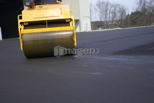 Steam rollers paving new asphalt; Canada, Ontario, Hamilton (Composting Facility)