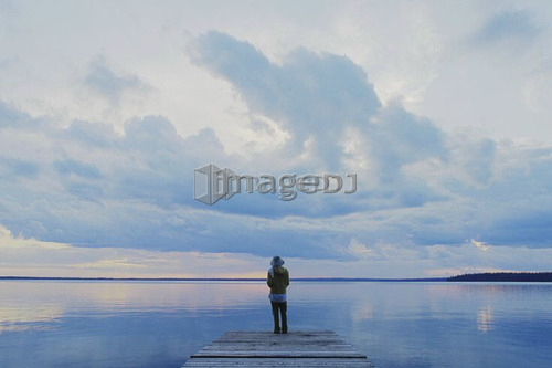 Woman on public dock Clear Lake; Canada, Manitoba, Riding Mountain National Park