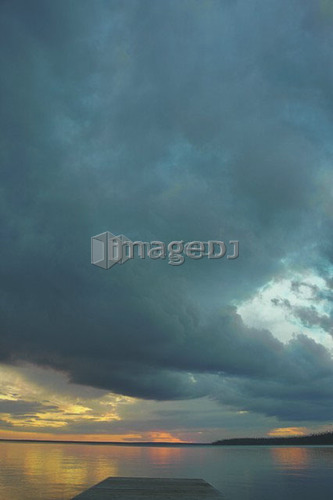 Rain clouds over Clear Lake; Canada, Manitoba, Riding Mountain National Park