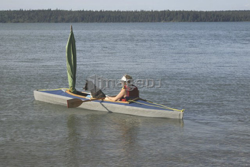 45 year old woman boating in Clear Lake,; Canada, Manitoba, Riding Mountain National Park