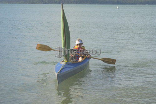 45 year old woman boating in Clear Lake,; Canada, Manitoba, Riding Mountain National Park