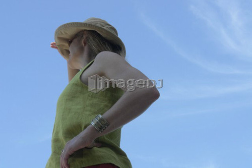 Woman looking out over Lake; Canada, Manitoba, Riding Mountain National Park