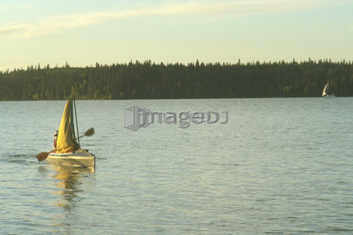 45 year old woman Kayaking on Clear Lake; Canada, Manitoba, Riding Mountain National Park