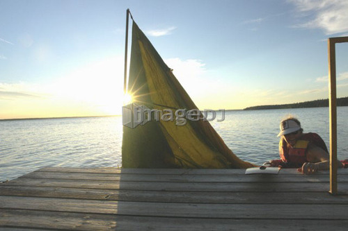 45 year old woman Kayaking on Clear Lake; Canada, Manitoba, Riding Mountain National Park