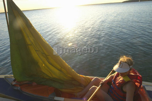 45 year old woman Kayaking on Clear Lake; Canada, Manitoba, Riding Mountain National Park
