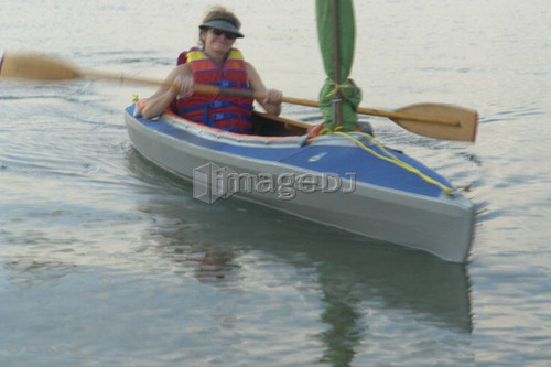 45 year old woman kayaking on Clear Lake; Canada, Manitoba, Riding Mountain National Park