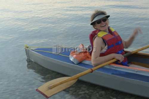 45 year old woman kayaking on clear Lake; Canada, Manitoba, Riding Mountain National Park