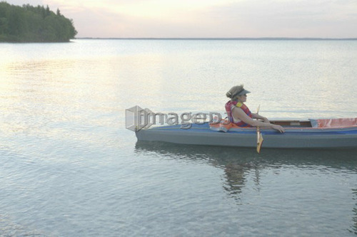 Woman in kayak Clear Lake Riding Mt. Nat. Park; Canada, Manitoba, Riding Mountain National Park