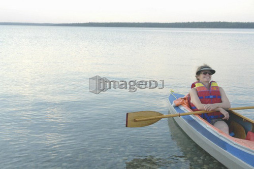 Woman in kayak Clear Lake Riding Mt. Nat. Park; Canada, Manitoba, Riding Mountain National Park