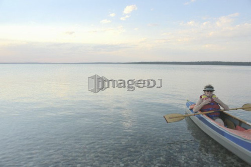 Woman in kayak Clear Lake Riding Mt. Nat. Park; Canada, Manitoba, Riding Mountain National Park