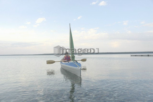 Woman in kayak Clear Lake Riding Mt. Nat. Park; Canada, Manitoba, Riding Mountain National Park