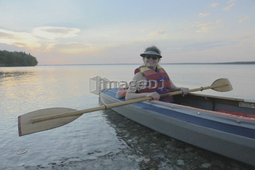 Woman in kayak Clear Lake Riding Mt. Nat. Park; Canada, Manitoba, Riding Mountain National Park