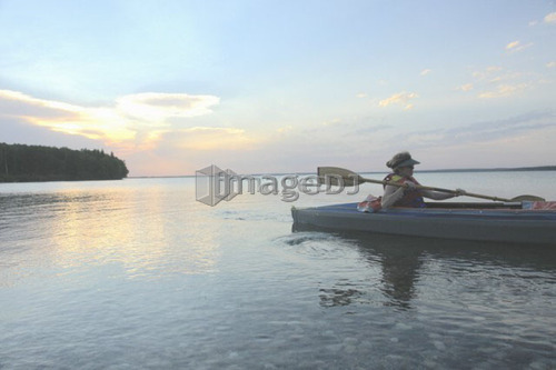 Woman in kayak Clear Lake Riding Mt. Nat. Park; Canada, Manitoba, Riding Mountain National Park