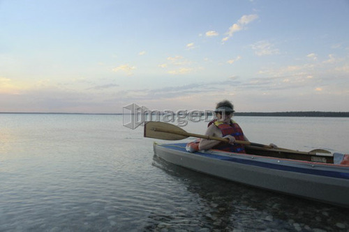 Woman in kayak Clear Lake Riding Mt. Nat. Park; Canada, Manitoba, Riding Mountain National Park