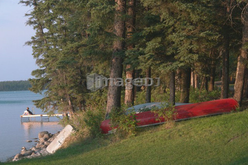 Woman on dock Clear Lake; Canada, Manitoba, Riding Mountain National Park