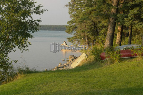 Woman on dock Clear Lake; Canada, Manitoba, Riding Mountain National Park