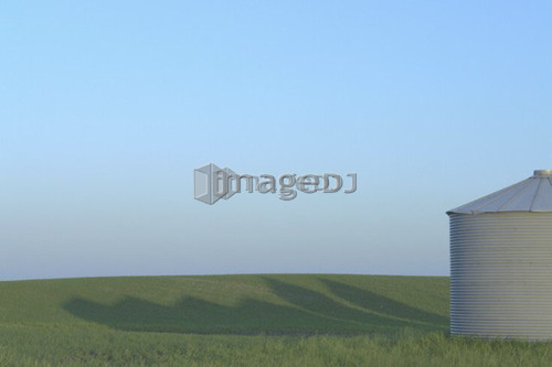 Metal Grainery and shadow; Canada, Manitoba, Erickson