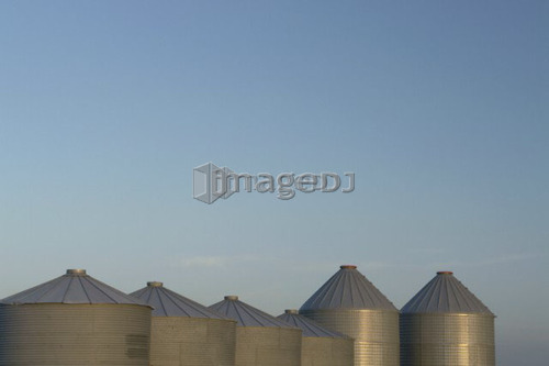 Row of metal graneries; Canada, Manitoba, Erickson