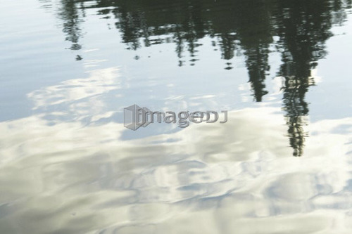 Reflection of clouds in Clear Lake, Riding Mountain National Park; Canada